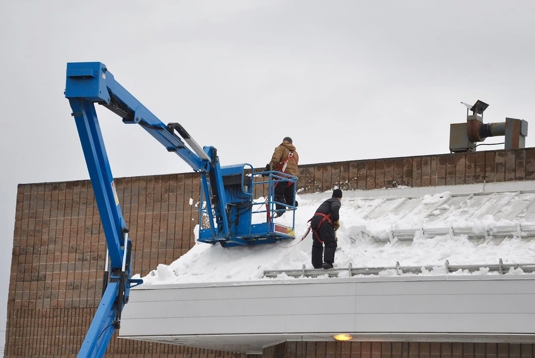 Commercial Roof Snow Removal-2 Employee Doing snow removal working